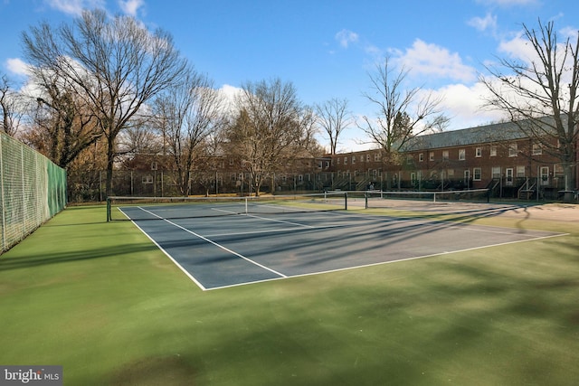 view of sport court featuring fence