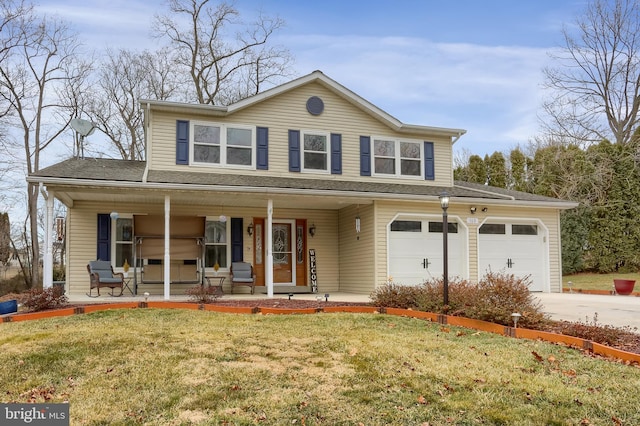 view of front facade with a garage, driveway, a front lawn, and a porch