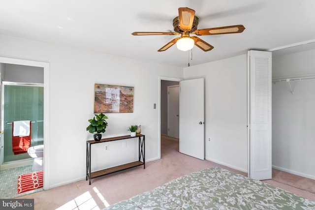 bedroom with a ceiling fan, baseboards, a closet, and ensuite bathroom