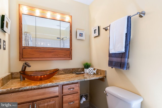 bathroom featuring toilet and vanity