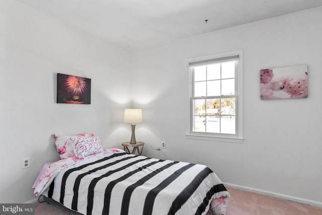 bedroom with carpet flooring and baseboards