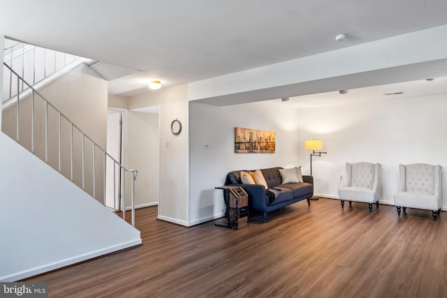 living room with stairway, wood finished floors, and baseboards