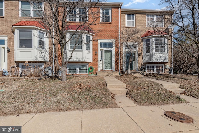 townhome / multi-family property with brick siding