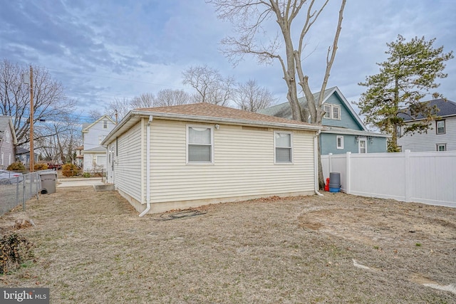 view of side of home with fence