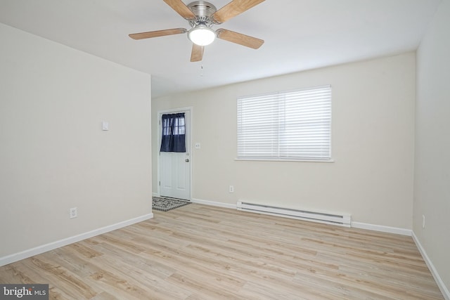 empty room featuring a ceiling fan, baseboards, baseboard heating, and wood finished floors