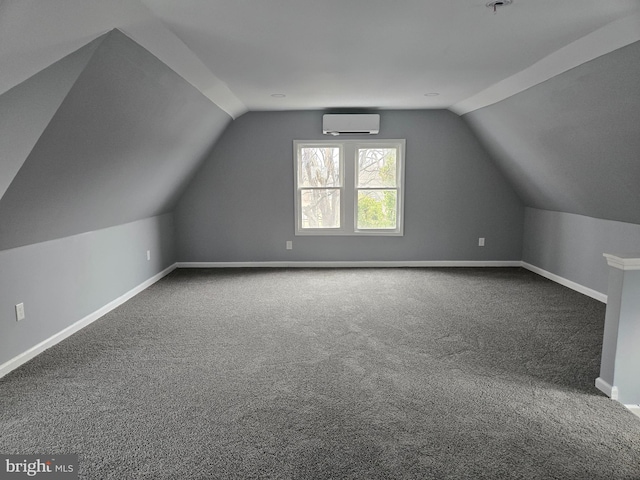 additional living space featuring carpet floors, lofted ceiling, baseboards, and a wall mounted AC