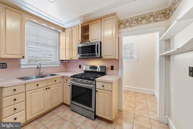 kitchen with a sink, light brown cabinetry, light countertops, stainless steel appliances, and open shelves