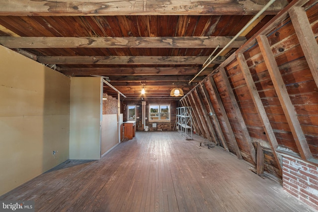 interior space featuring beam ceiling and wood-type flooring