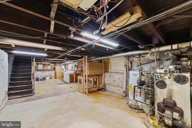 unfinished basement with gas water heater and washer / clothes dryer