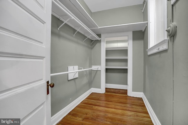 walk in closet featuring wood finished floors