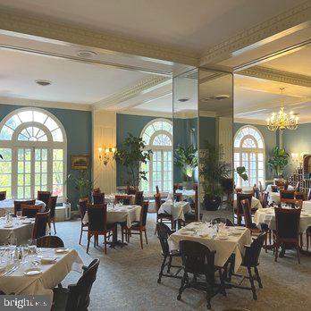 dining space with a chandelier and carpet