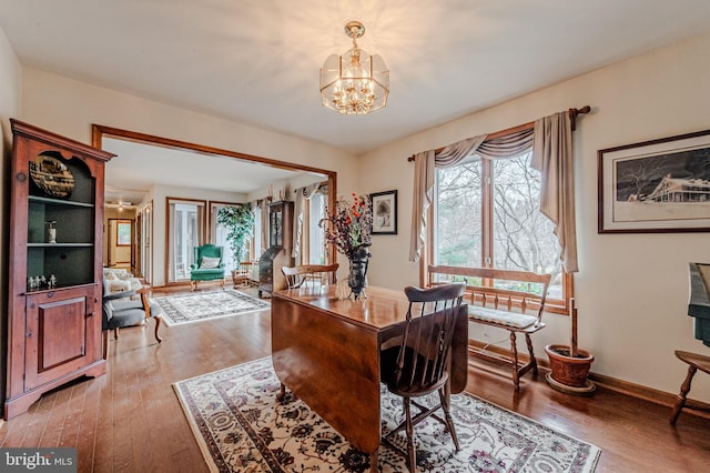 office area with an inviting chandelier, baseboards, and hardwood / wood-style floors