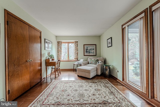 sitting room featuring baseboards and wood finished floors