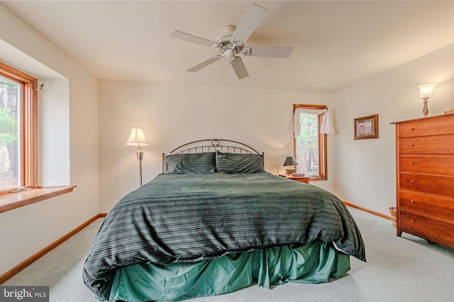 bedroom with carpet floors, multiple windows, and baseboards