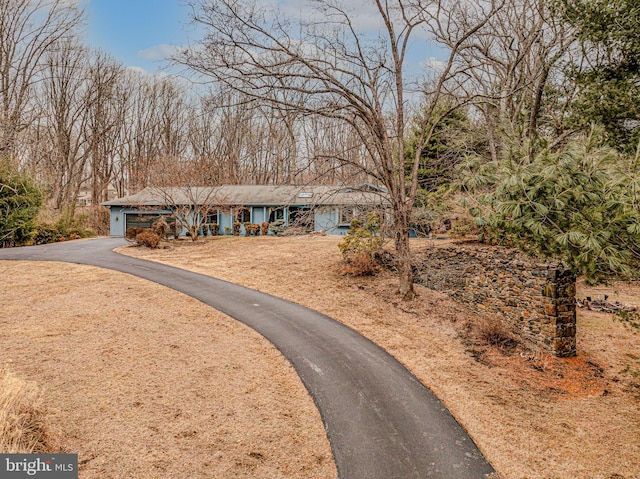 view of front of home featuring a garage and aphalt driveway