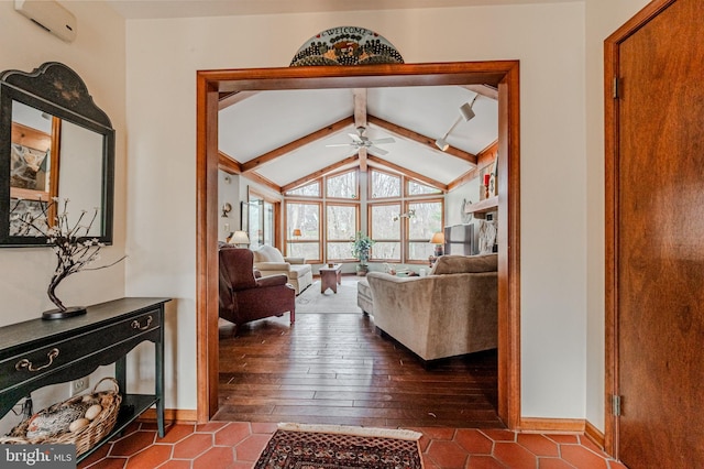 interior space featuring lofted ceiling with beams, baseboards, dark wood-style flooring, and a ceiling fan