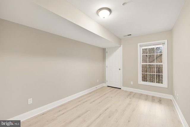 unfurnished room with light wood-style floors, baseboards, and visible vents