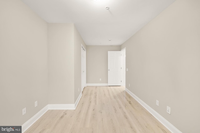 unfurnished room with baseboards and wood finished floors