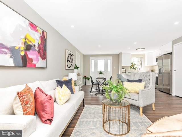 living area featuring dark wood finished floors, french doors, and recessed lighting