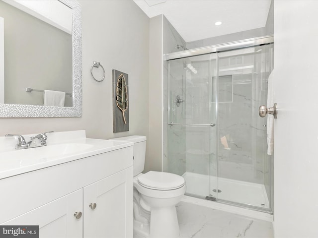 bathroom featuring marble finish floor, vanity, a marble finish shower, and toilet