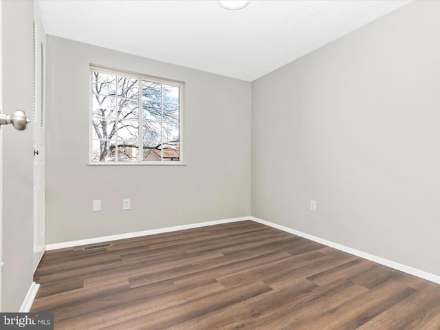 interior space featuring visible vents, dark wood finished floors, and baseboards