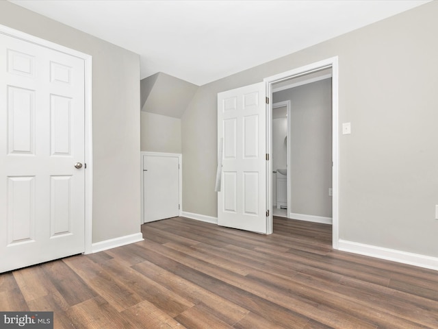 interior space with baseboards and wood finished floors