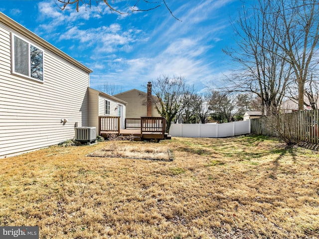 view of yard featuring a fenced backyard, cooling unit, and a wooden deck