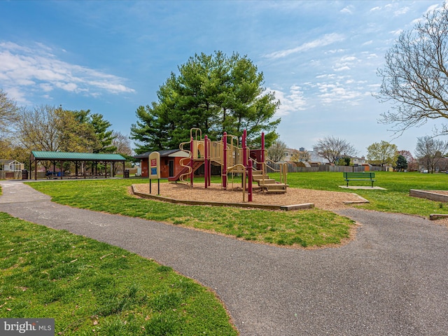 community jungle gym featuring a lawn