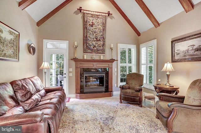 living area featuring beamed ceiling, a premium fireplace, high vaulted ceiling, and baseboards