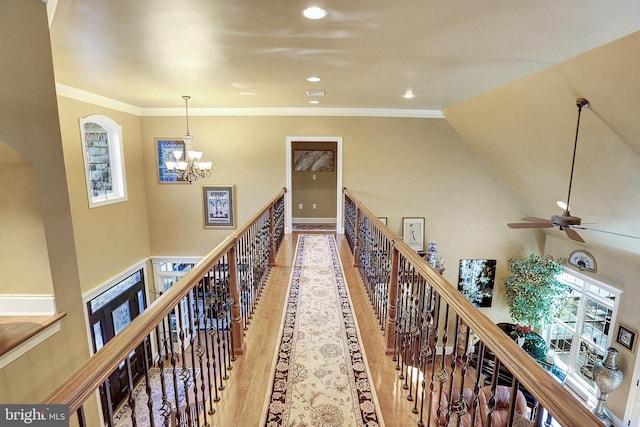 hall featuring ornamental molding, recessed lighting, an upstairs landing, and wood finished floors