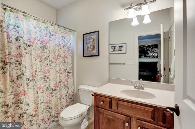 bathroom featuring curtained shower, vanity, and toilet