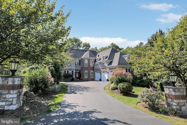 view of front of property featuring a garage and aphalt driveway