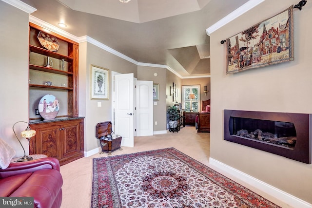 living room featuring baseboards, built in features, a glass covered fireplace, ornamental molding, and carpet