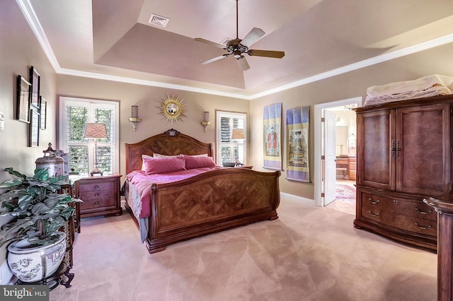 bedroom featuring light carpet, visible vents, a raised ceiling, and crown molding