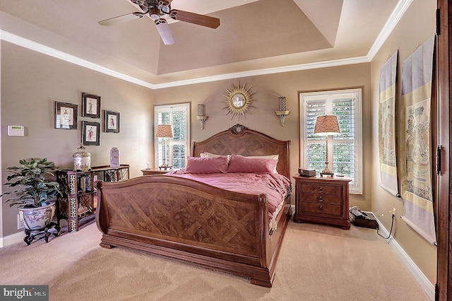 bedroom featuring carpet floors, multiple windows, a raised ceiling, and baseboards