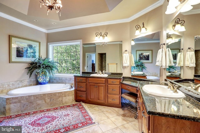 full bathroom featuring a chandelier, a garden tub, tile patterned floors, a tray ceiling, and crown molding