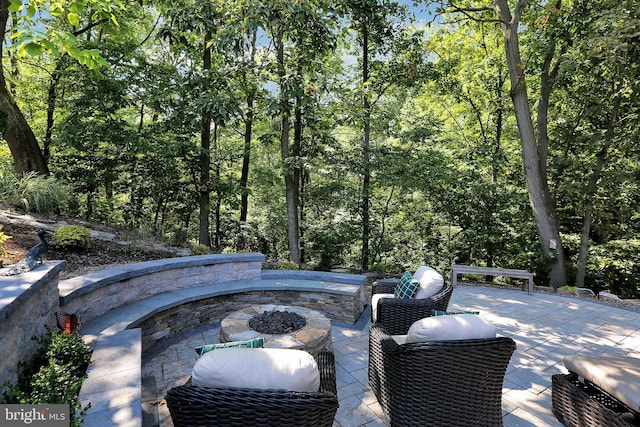 view of patio / terrace featuring an outdoor fire pit