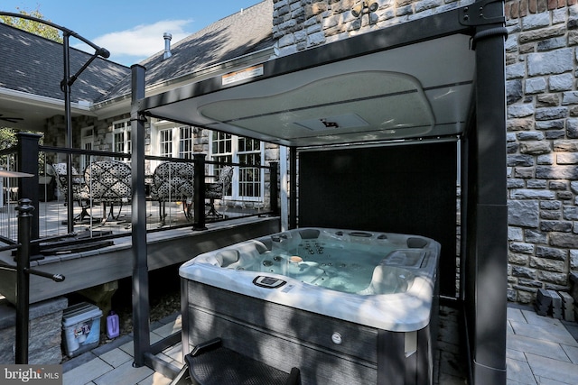 exterior space with a hot tub