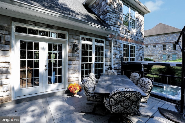 deck featuring outdoor dining space and french doors