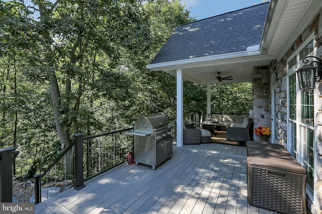 wooden terrace with a ceiling fan, area for grilling, and an outdoor hangout area