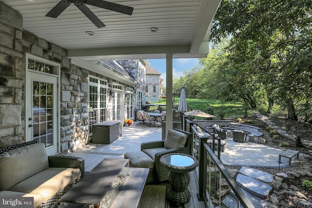 view of patio with ceiling fan and a deck