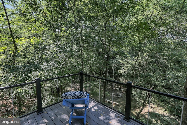 wooden terrace with a wooded view