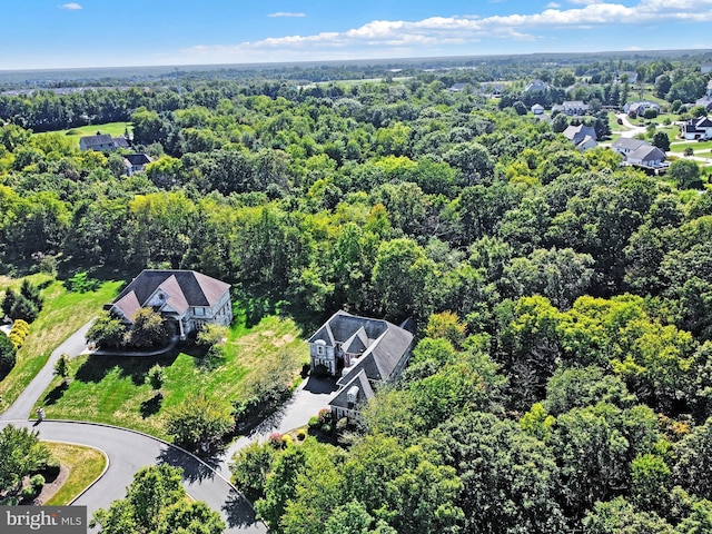 birds eye view of property featuring a forest view