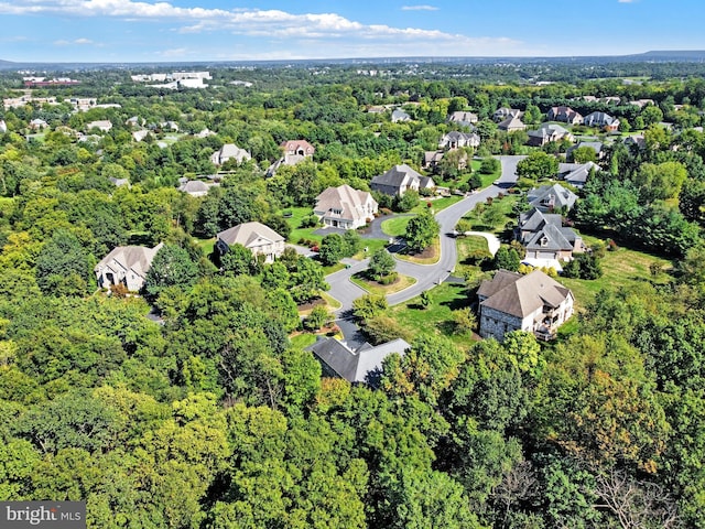 birds eye view of property with a wooded view and a residential view