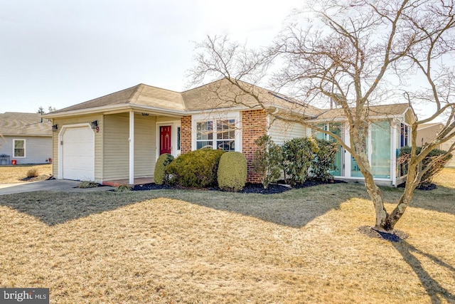 single story home with concrete driveway, brick siding, an attached garage, and a front lawn