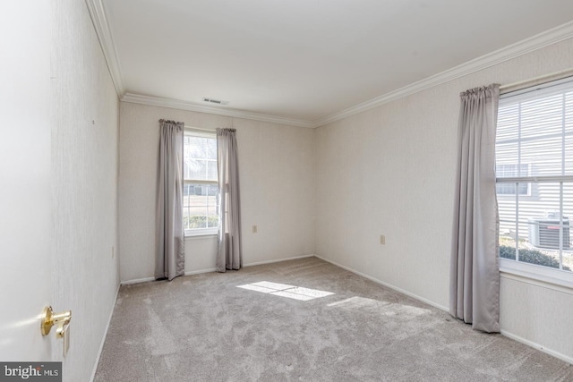 unfurnished room featuring visible vents, ornamental molding, and light colored carpet