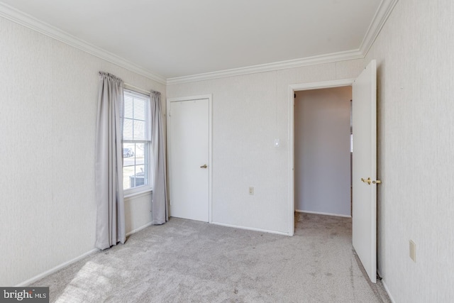 unfurnished bedroom with light colored carpet and crown molding