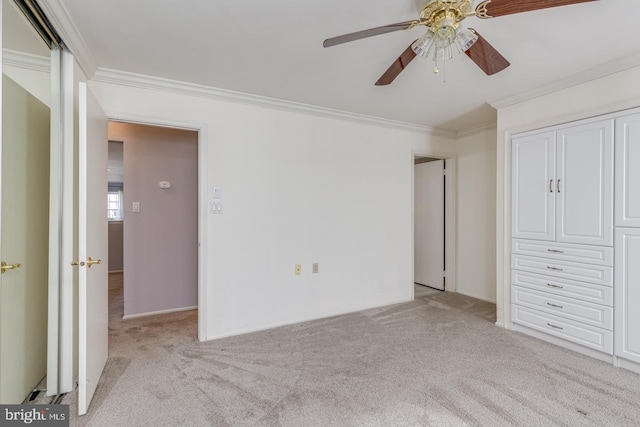 unfurnished bedroom with ornamental molding, light carpet, and a ceiling fan