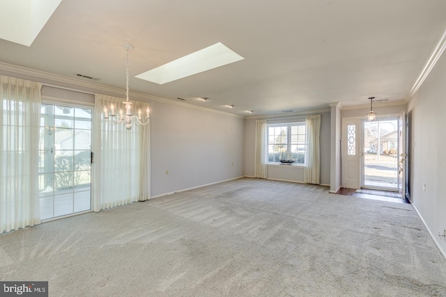 unfurnished room featuring light carpet, a skylight, and ornamental molding