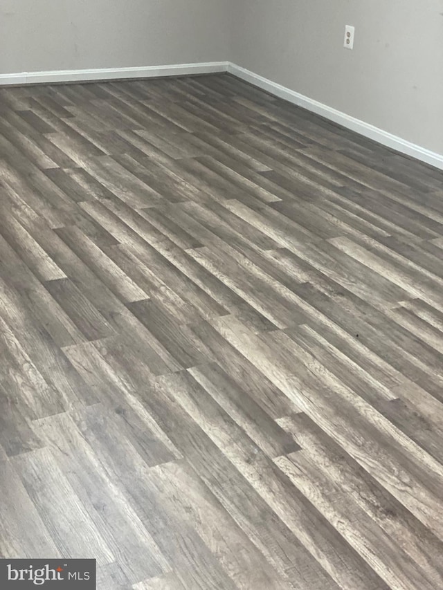 interior details with baseboards and wood finished floors